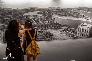 Schoolgirls look at a panoramic images of Hiroshima after the bombing in 1945.