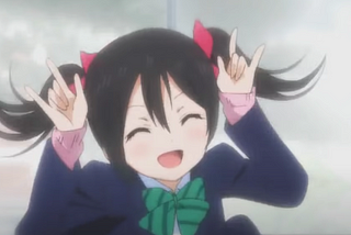 An image of character Nico Yazawa doing her signature ‘Nico Nico Nii’ pose