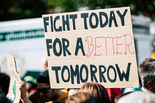 Protest with a sign reading “fight for a better tomorrow”