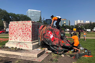 BREAKING: Angry Commonwealth protestors topple and deface statues of Queen Elizabeth and her great-great-grandmother Victoria