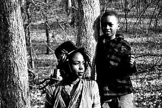 A women, and a child, in the woods.