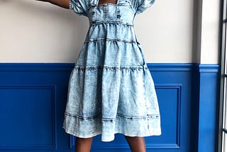 Marcela smiles joyfully while raising hands