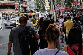 Image of people on a busy street of a city in the Philippines