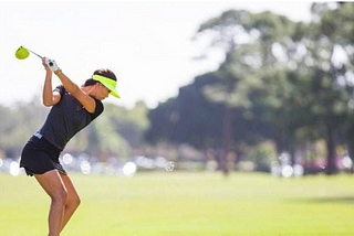 woman golfing with a non-brand name club, demonstrating the placebo effect