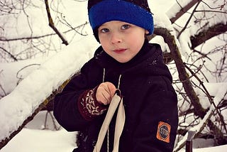 A boy with a slingshot in his hands