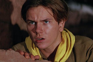 A young Indiana Jones (River Phoenix) stares