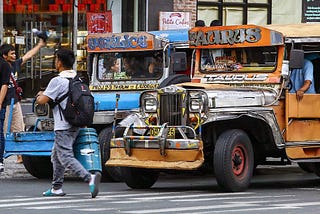 Photo: Traditional jeepneys stop at a pedestrian crossing (https://www.pna.gov.ph/photos/70310)