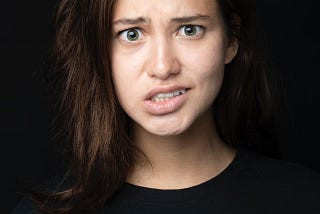 Young woman looking dismayed