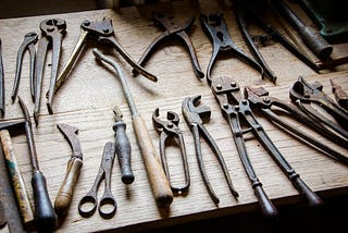 A set of old tools laying on a workbench