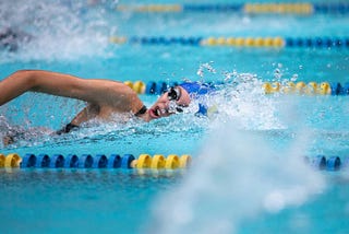 woman swimming laps in a school