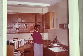 Image of a black woman working in tech services caption “Mending Department. Mrs. Dora Lee Johnson”