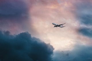 Airplane in the sky, surrounded by clouds.