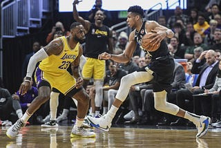 LeBron James (23) of the Los Angeles Lakers guarding the driving Giannis Antetokounmpo (34) of the Milwaukee Bucks.