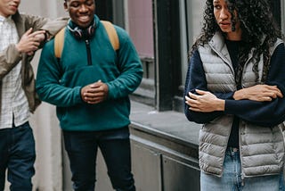 Woman being harassed by two men on the street.