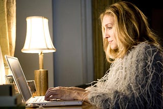 Carrie Bradshaw writing on her laptop in Sex and the City