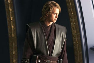 Anakin Skywalker stares out a window broodingly during Revenge of the Sith. With his long hair, facial scar, and dark clothing he is effectively being communicated as tainted by the dark even before he falls.