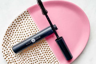 Lily Lolo Big Lash Mascara on a pink and white saucer