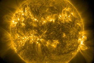 The Sun, with material arcing out and a bright flare visible on its right side