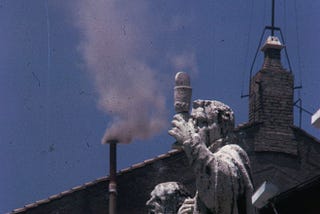 White smoke billows from the Sistine Chapel, announcing the election of a new Pope.