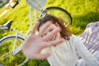 A girl raising her hand and protecting from photos