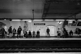 People from all walks of life at a train station in Paris.