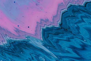 An illustration of a body of water. Deep blues pours out of one corner of the image; luminous pink-purple pours out of the opposite corner. Where the two meet and create a zig-zagging break runs across the middle of the image