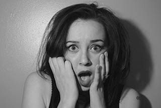 Black and white photo of a woman in shock