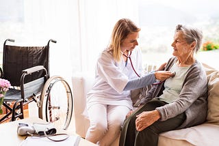 An elderly patient receiving hospice care at home from her nurse