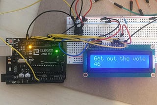 An Arduino board with an LCD screen I designed to read “Get out the vote.”