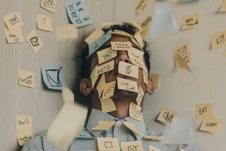 Man with eyes closed and post-its on his head.