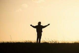 silhouette of person spreading hands