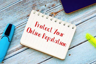 Notepad with the words, 'Protect your Online Reputation' written on the front page.