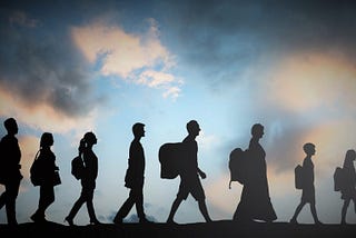 silhouette image of people migrating