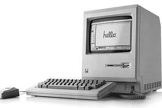 Original Macintosh computer with “Hello” written on screen