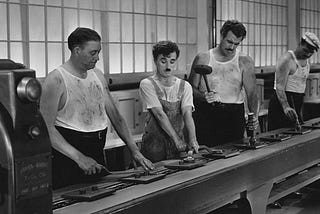 Still from the motion picture ‘Modern Times’ from Charles Chaplin showing a worker on a manufacture line.