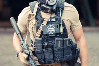 Andrew Tate wearing a completely ridiculous fake tactical kit.