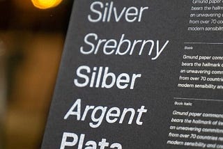 Photo of different fonts and their descriptions. The text is in white, printed on black paper.