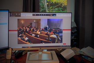 Funeral as a hybrid event. Some people in the room, the others watch online.