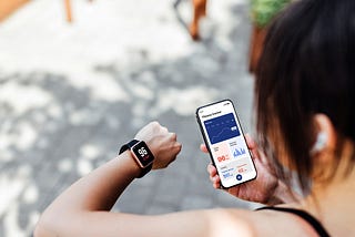 Lady checking her fitness watch and fitness app