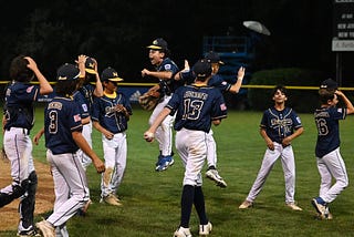 Massapequa (NY) players celebrate as they win and qualify for the 2022 Little League World Series.