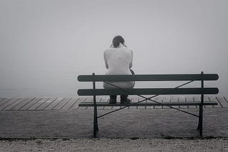 woman sitting alone on beach