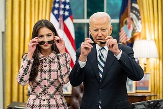 Joe Biden and Olivia Rodrigo encouraging Covid vaccination. Both are donning Biden’s signature aviator sunglasses.