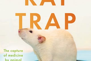 ‘Rat Trap’ book cover. Title in large orange print in the middle, with a photo of a white rat underneath. The subtitle is printed in smaller, green print to the left of the rat.