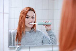 A woman cleaning her teeth