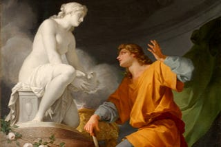 A painting depicting Pygmalion kneeling before his statue of Galatea. Pygmalion is dressed in an orange robe, gazing up in awe at Galatea, who is depicted as a white marble statue coming to life.