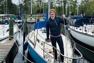 Photo of author standing on his sailboat