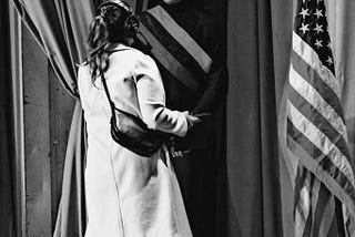Cayden Brown standing next to the American flag before addressing juvenile justice leaders at the Department of Justice