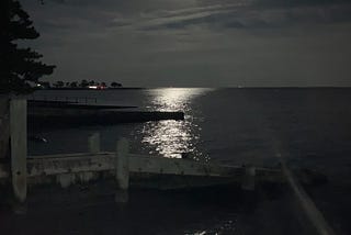 The Blue Supermoon illuminates the night sky and shimmers in the water as it rises over the Long Island Sound.