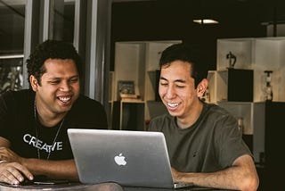Colleagues deep in conversation in front of a laptop