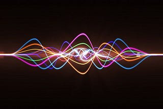 Multiple colored sound waves combined together, dark background